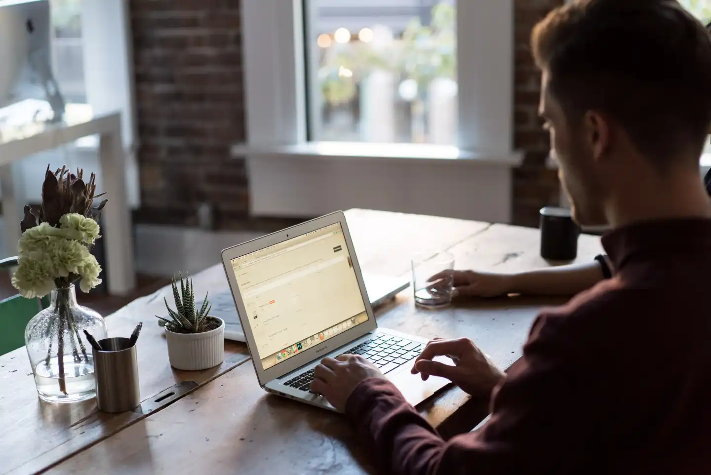 man-operating-laptop-on-table